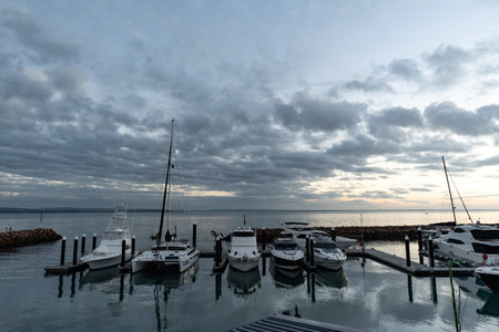 Boats moored in a marina at sunsetの写真素材