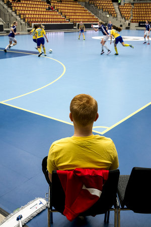 Ballboy sitting and waitin for a ball to fetch