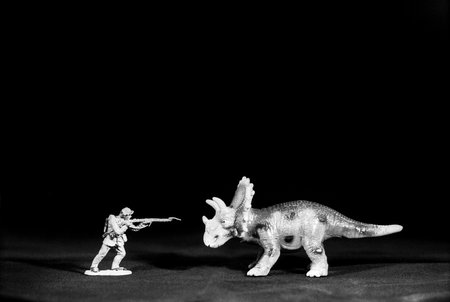 Toy soldier hunting a plastic dragonの写真素材