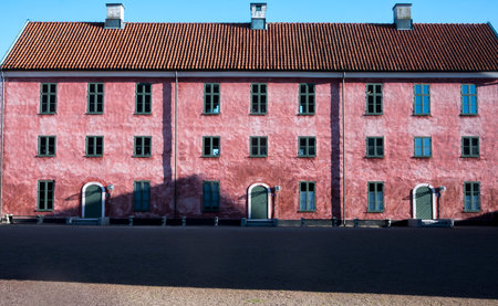 A part of Landkrona castle from the middle age. The front is enlightened by sun and the shadow creeping at the ground.の写真素材