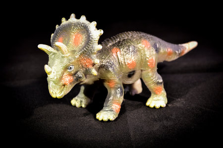 Still life of a plastic toy dragon with dark backgroundの写真素材