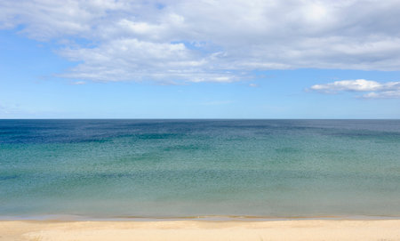 The overwhelming sea meets the cloudy sky at the horizonの写真素材