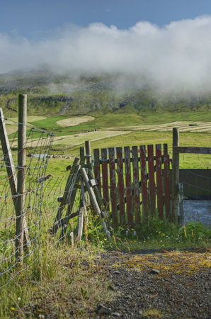 Old wooden gate with husked red paintの写真素材