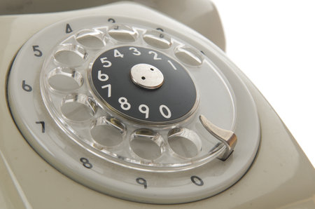 a closeup of an old gray phone dialing ringの写真素材