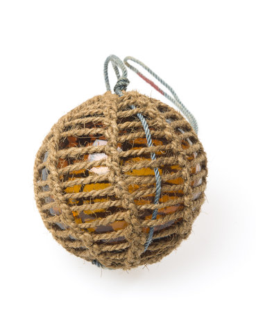 Glass fishing buoy used to keep fishing nets floating. This is an old glass antique. Isolated on white background.の写真素材