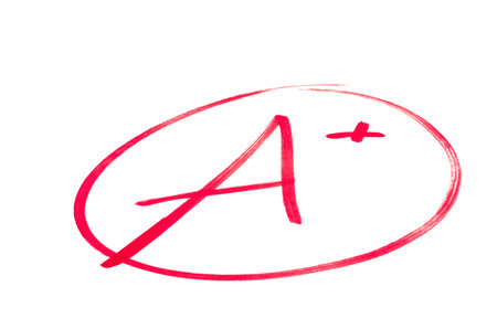 A handwritten grade for an excellent achievementsin red ink  Isolated on white の写真素材