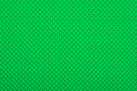 Green fabric with dots, a textile background の写真素材