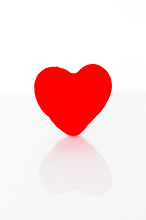 Red heart with reflection on a white background の写真素材