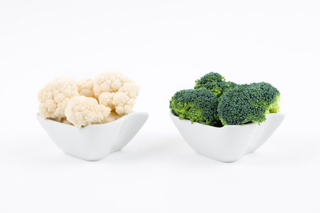 Fresh broccoli and cauliflower in a porcelain bowlsの写真素材