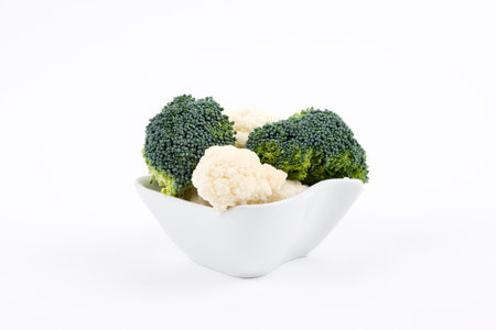 Broccoli and cauliflower in a porcelain bowlの写真素材