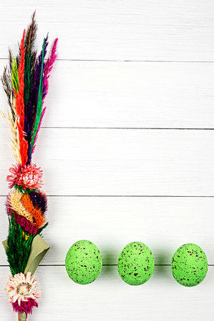 Easter Palm and easter eggs on a white plankの写真素材