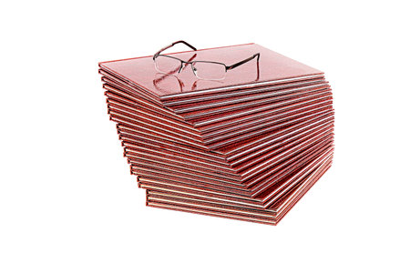 Pile of books and glasses on white backgroundの写真素材