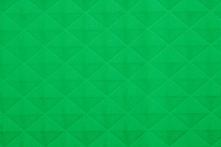 Green fabric with geometric patterns, a background or textureの写真素材