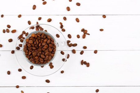 Coffee beans in the cup on a wooden backgroundの写真素材