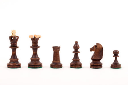 Wooden chess pieces on a white backgroundの写真素材
