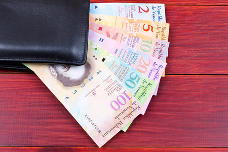 Venezuelan money in the black walletの写真素材
