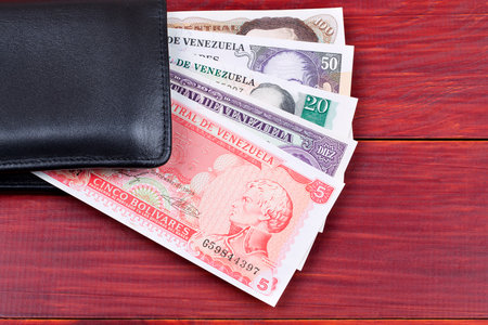 Old Venezuelan money in the black walletの写真素材