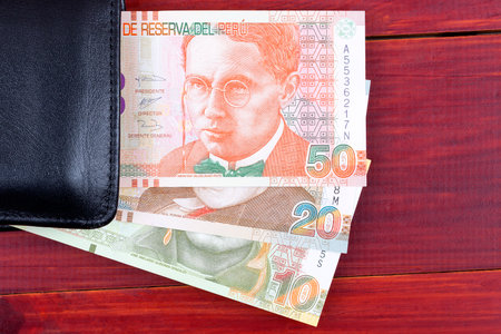 Peruvian money in the black walletの写真素材