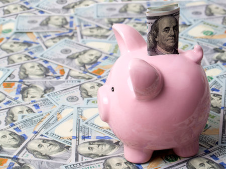 Pink piggybank with American dollarsの写真素材