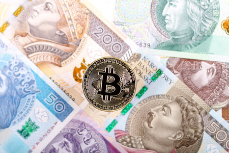 Bitcoin coin on the background of Polish banknotesの写真素材