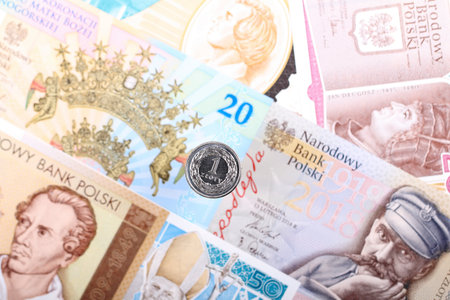 Polish Zloty coin on the background of Polish banknotesの写真素材