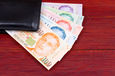 Singapore dollars in the black walletの写真素材