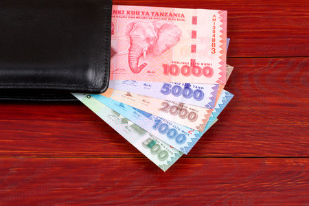 Tanzanian money in the black walletの写真素材