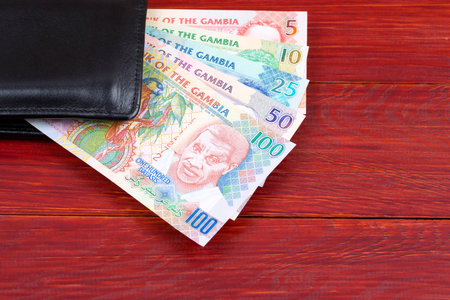 Gambian money in the black walletの写真素材