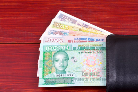 Guinean money in the black walletの写真素材