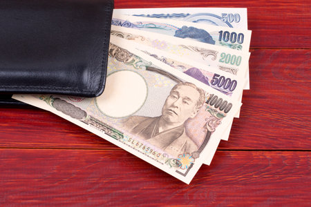 Japanese money in the black walletの写真素材