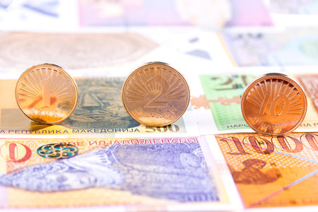 Macedonian Denar coins on the background of banknotes