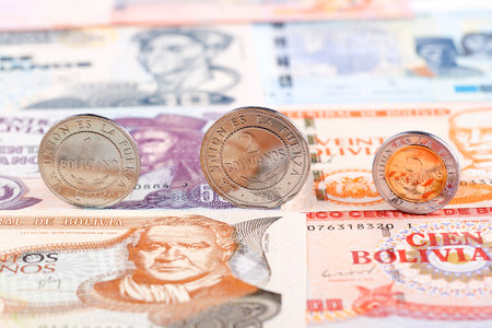 Bolivian Boliviano coins on the background of banknotesの写真素材