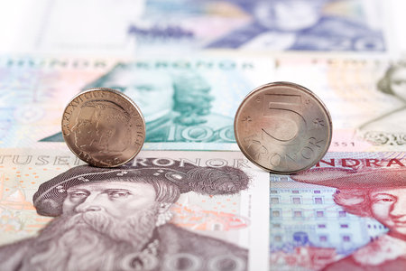 Swedish coins on the background of old banknotesの写真素材