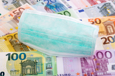 Protective mask on a European money backgroundの写真素材