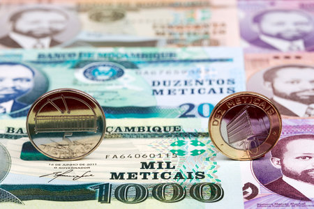Mozambican coins - metical on the background of moneyの写真素材