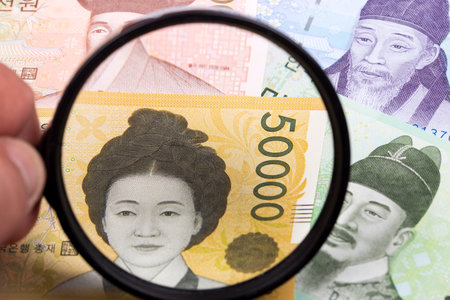 South Korean money in a magnifying glass a business backgroundの写真素材