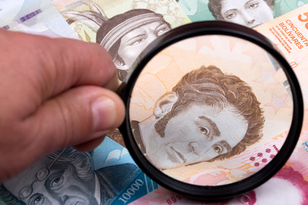 Venezuelan money in a magnifying glass a business backgroundの写真素材