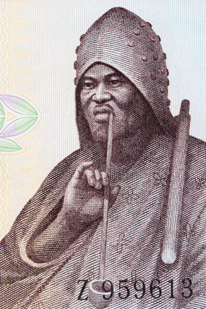 Man smoking a pipe a portrait from old Guinean moneyのeditorial素材