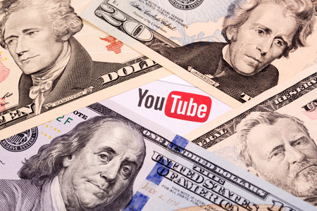 Warsaw, Poland - June 13, 2022: YouTube logo on American money - dollars.