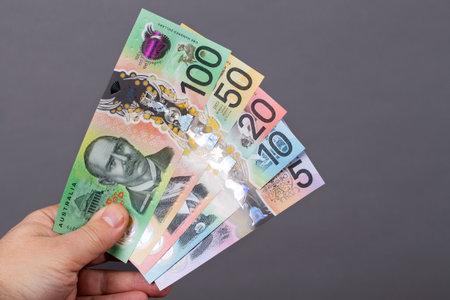 Australian money - dollars in the hand on a gray backgroundの写真素材