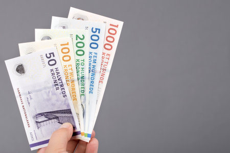 Danish money - crowns - in the hand on a gray backgroundの写真素材