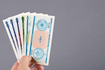 Cuban money - peso in the hand on a gray backgroundの写真素材