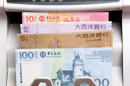 Macanese money - pataca in a counting machineの写真素材