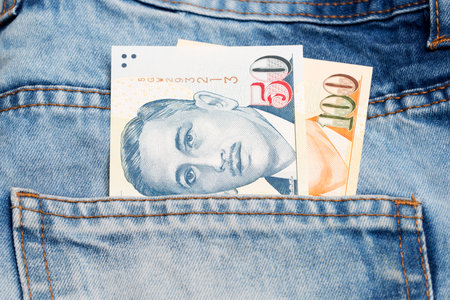 Singapore money - dollar in the pocket of blue jeans