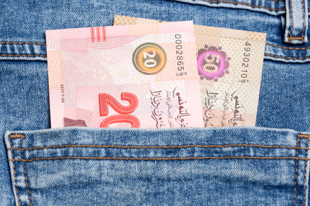 Tunisian money - dinar in the pocket of blue jeansの写真素材