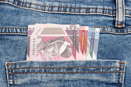 Guinean money - franc in the pocket of blue jeansの写真素材