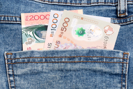 Mauritian money - rupee in the pocket of blue jeansの写真素材