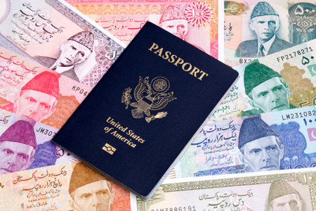 American passport on a Pakistani money - Rupeeの写真素材