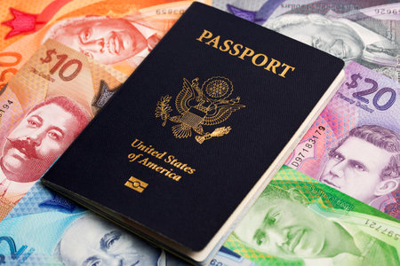 American passport on Barbadian money - dollarの写真素材