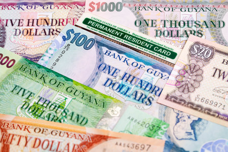 American permanent resident card on Guyanese money - dollarの写真素材